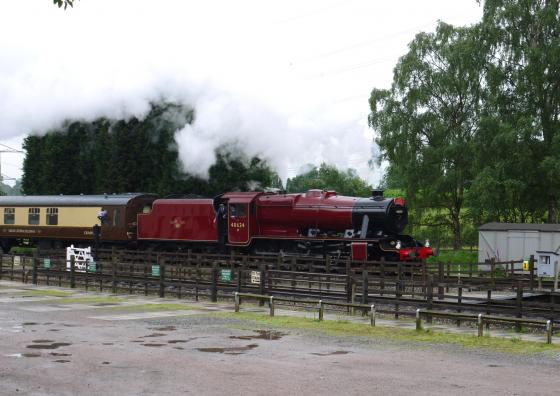 Steam Engine 48624 with a film cameraman recording the journey from the front carriage