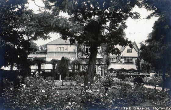 Side view of The Grange showing how lovely the gardens were in 1917. At the foot of the sundial is a stone lion which was later moved to the back of the house when this area was put to other uses.