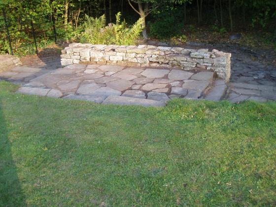 The paving and front wall with the half moon pond over the wall. September 2011